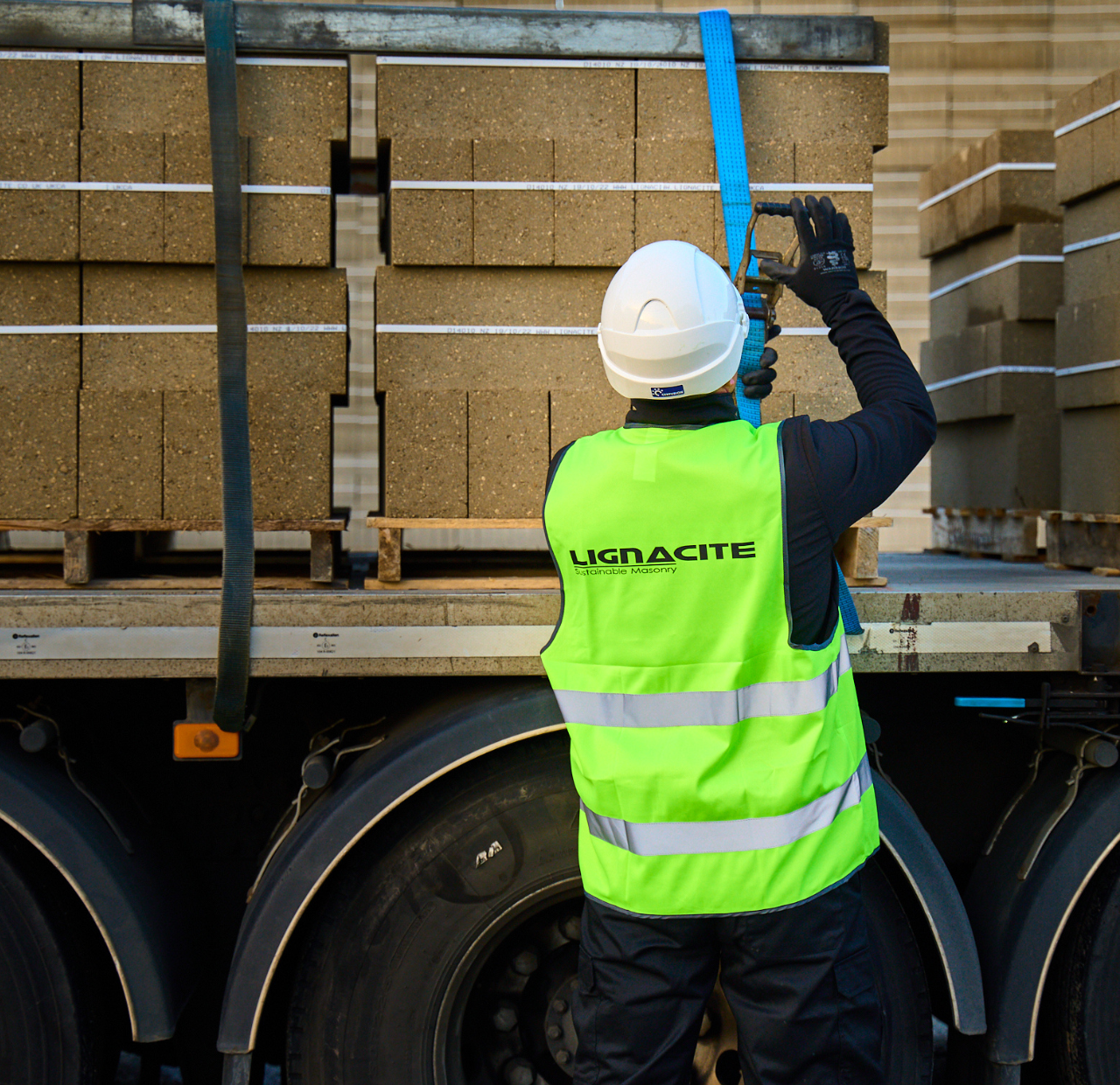 Lignacite staff strapping down concrete blocks