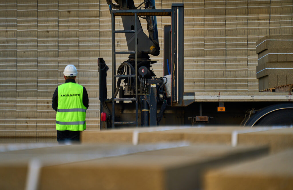 A member of staff at sustainable masonry company Lignacite loads concrete blocks